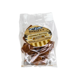 A transparent bag containing pieces of Fudge. The bag has a label on it that shows Romney's logo and says 'Crumbly Butter Fudge'.