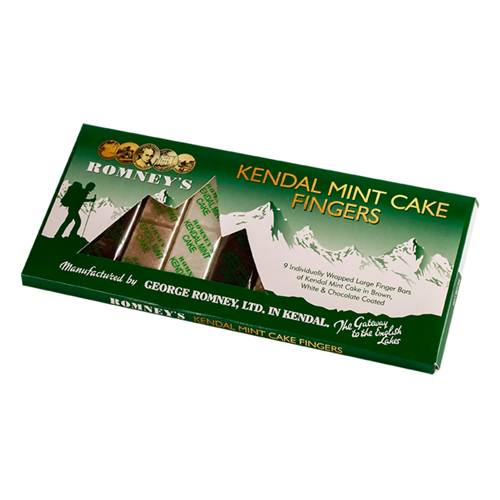A rectangular cardboard box containing 9 Kendal Mint Cake fingers. The flavours contained are White, Brown & Chocolate Coated Kendal Mint Cake, all of which are individually wrapped in a transparent wrapper and a number of the fingers are visible through mountain shaped window. The box is mainly green with a white mountain backdrop. It also features the Romney's logo and the words 'Kendal Mint Cake Fingers' are written in gold font. The box is at a 45 degree angle to the right
