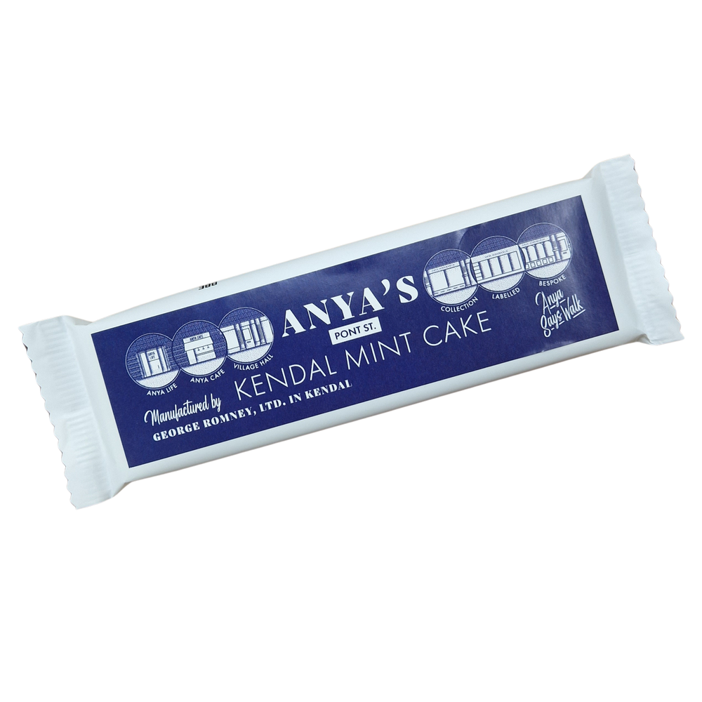 a bar of Kendal Mint Cake in a plain white wrapper. The bar has a label covering the front, bespoke to the company Anya Hindmarch