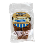 A transparent bag containing pieces of Fudge. The bag has a label on it that shows Romney's logo and says 'Clotted Cream Fudge'.