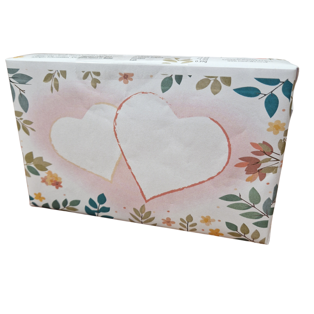 a box wrapped in a flowery mother's day themed paper, featuring two large hearts on the reverse of the box