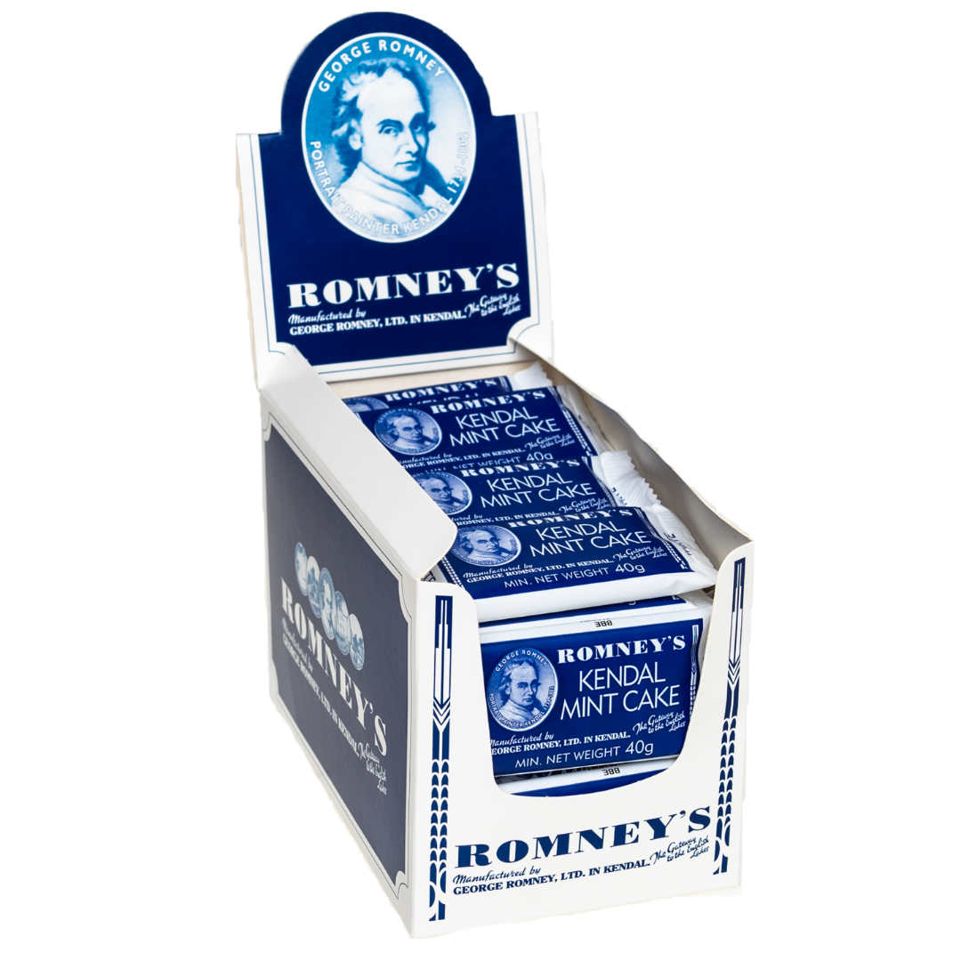 A product image showing an open cardboard box which is used to display products on a shelf and is white and blue. The box contains 40g bars of Romney's White Kendal Mint Cake which is in a blue and white wrapper.