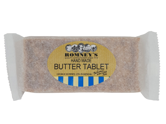 A product image of a rectangular bar of Butter Tablet confectionery in a paper style wrapper. The bar has a label on the front featuring the Romney's logo and the words 'Hand Made Butter Tablet'.