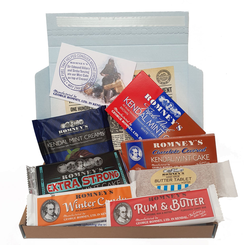 An open letter box gift set containing a 7 different confectionery products such as a Triple Bar of Romney's Kendal Mint Cake, a Chocolate Coated Kendal Mint Cake, Extra Strong Kendal Mint Cake, Rum & Butter Bar, Winter Candy Bar, Butter Tablet Bar & Kendal Mint Creams