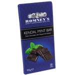 A rectangular bar of chocolate wrapped in a dark blue wrapper that features a repeating pattern. The front of the wrapper features the Romney's logo. A black band wraps around the middle of the bar and states 'Kendal Mint Bar' & 'Dark Chocolate with Peppermint Flavour'. The front of the wrapper also features an image of broken pieces of chocolate and mint leaves.