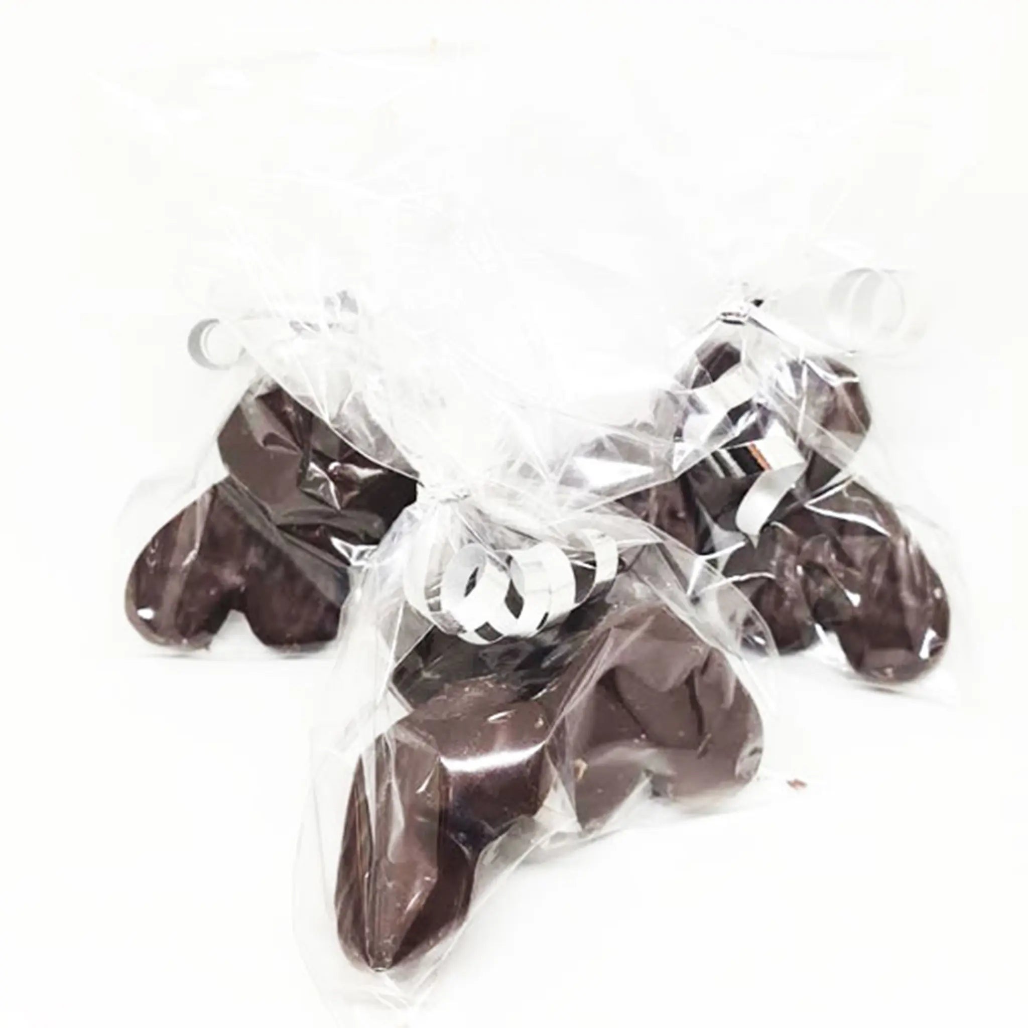 Three transparent bags with silver curly ribbon tied to the top of them. Each bag contains three chocolate covered Kendal Mint Cake Hearts