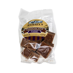 A transparent bag containing pieces of Fudge. The bag has a label on it that shows Romney's logo and says 'Chocolate Fudge'.