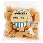 A product image showing a transparent bag filled with pieces of Cinder Toffee. The bag has a label stuck to the side that features the Romney's logo and the words 'Cinder Toffee'.