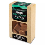 a rectangular cardboard box containing a transparent bag of fudge. The box has a black and green label that states 'Kendal Mint Cake Vodka Flavoured Fudge.
